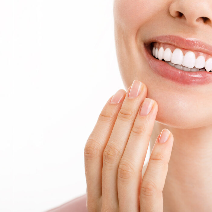 Perfect healthy teeth smile of a young woman. Teeth whitening. Dental clinic patient. Image symbolizes oral care dentistry, stomatology. Dentistry image Perfect healthy teeth smile of a young woman. Teeth whitening. Dental clinic patient. Image symbolizes oral care dentistry, stomatology. Dentistry image.